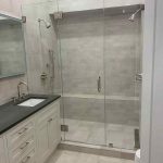 Modern bathroom remodel with rain shower Elegant bathroom design with marble countertops Small bathroom renovation with efficient storage Bathroom renovation with white and gray tiles Renovated rustic bathroom with wood details