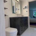 Modern bathroom remodel with rain shower Elegant bathroom design with marble countertops Small bathroom renovation with efficient storage Bathroom renovation with white and gray tiles Renovated rustic bathroom with wood details